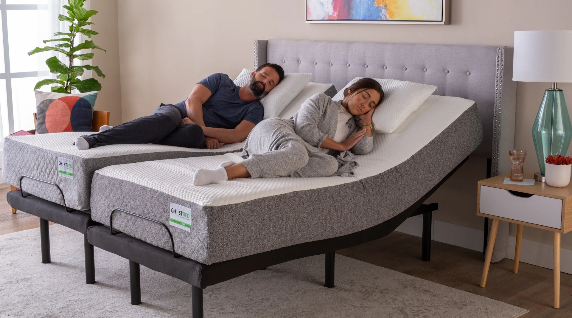 Couple sleeping on a GhostBed Split King Adjustable Bed Base
