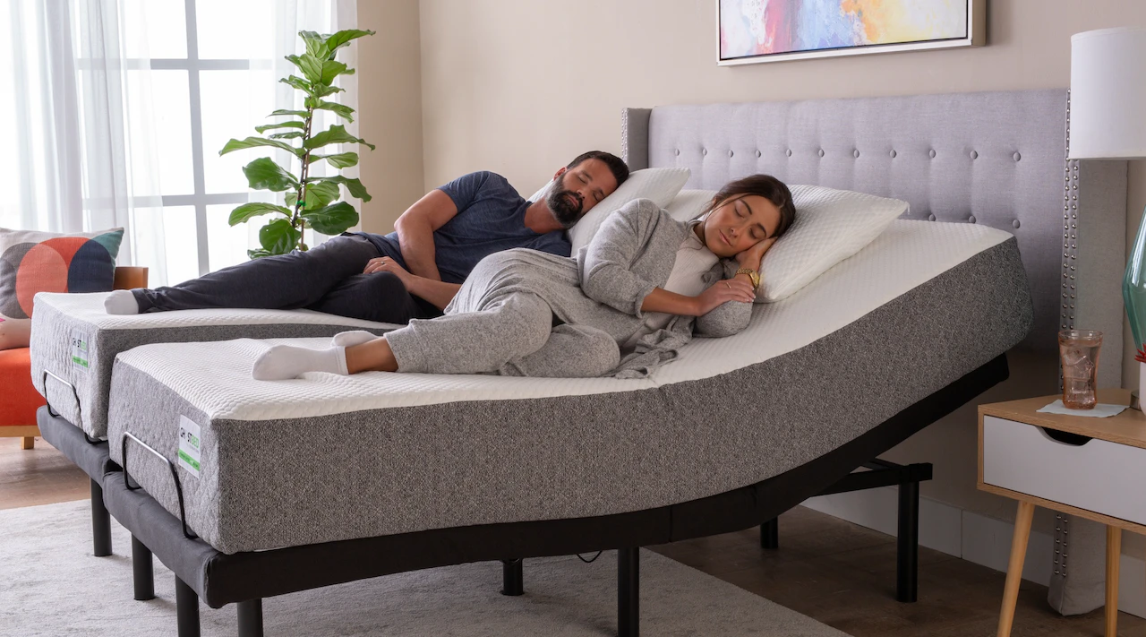 Couple sleeping on a split king mattress with adjustable base