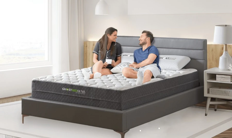 Couple relaxing on a queen size mattress